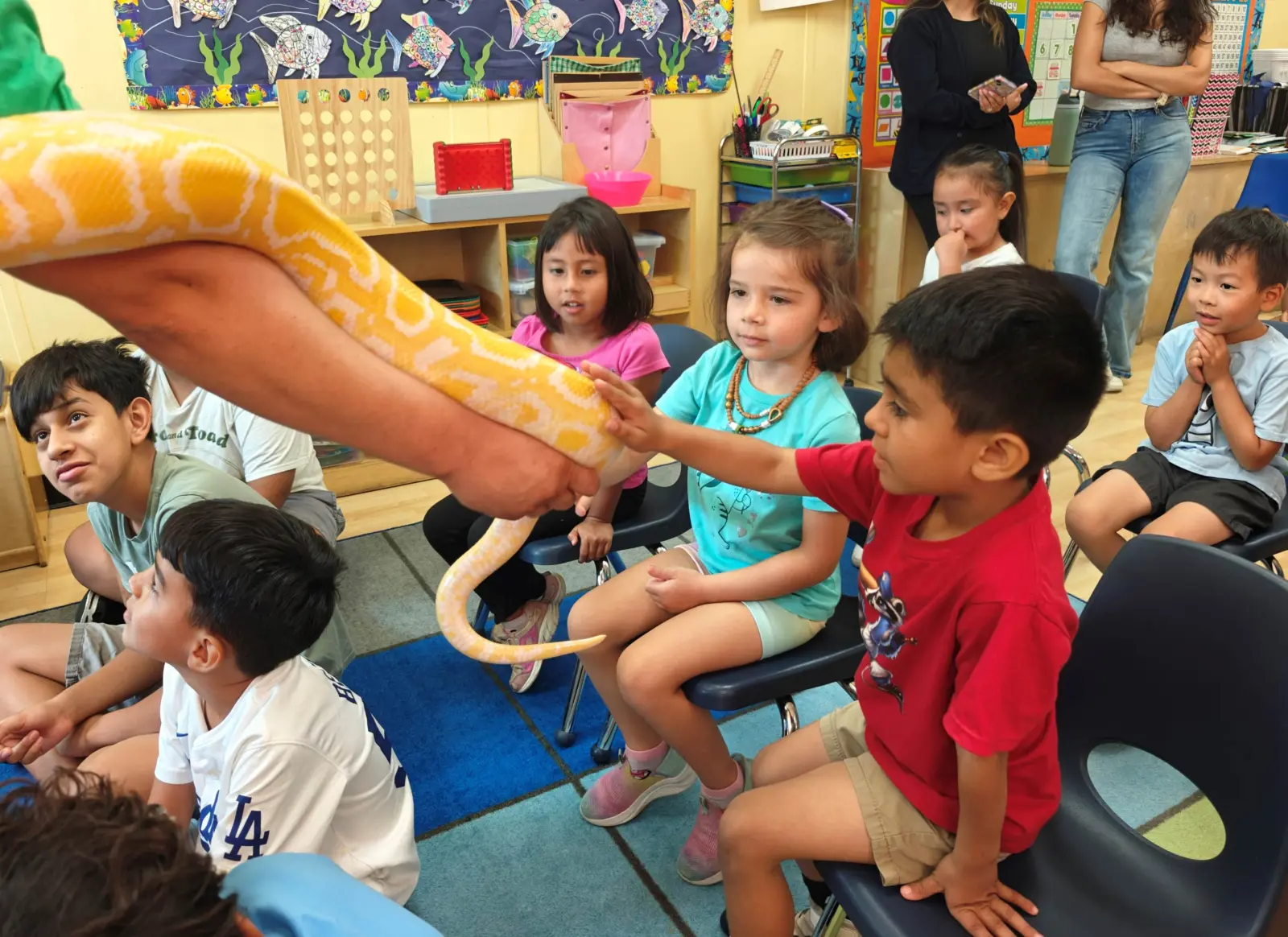 Children attending an interactive educational assembly with a special guest presenter at Kids Adventure Learning Center