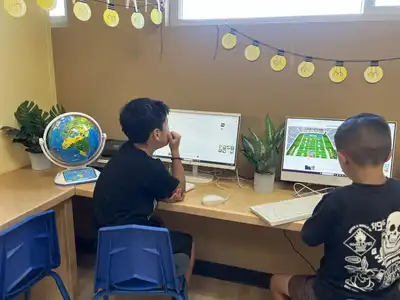 School-age children ages 5-12 doing computer activities in Kids Adventure Learning Center's before and after school care program