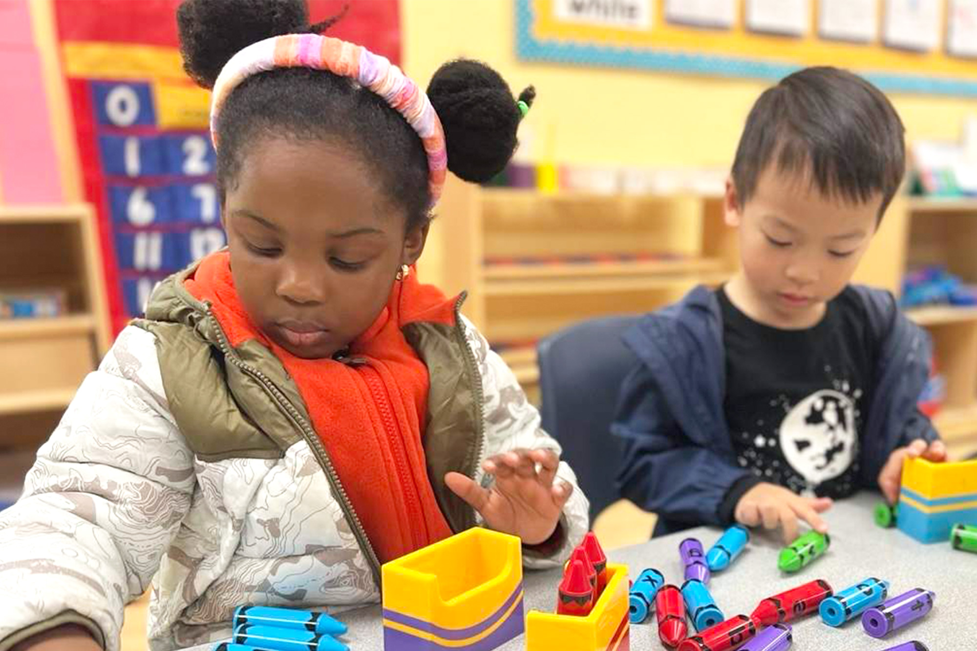 Buena Park-Transitional Kinder students participating in a fun group learning activity in a cheerful classroom.